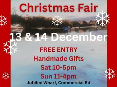 Jubilee Wharf Christmas Fair poster with view of the river in winter in the background.